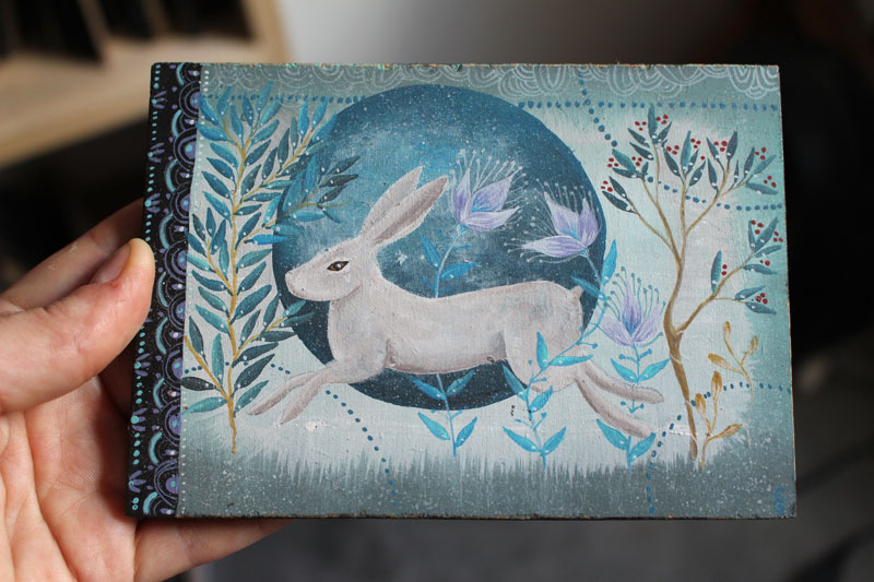 Winter hare, painting running in the countryside